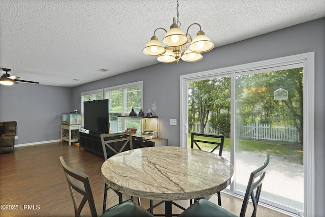 93 Heartstone Cir, Bluffton, SC 29910 - dining space with a chandelier, a textured ceiling, wood finished floors, baseboards, and a ceiling fan
