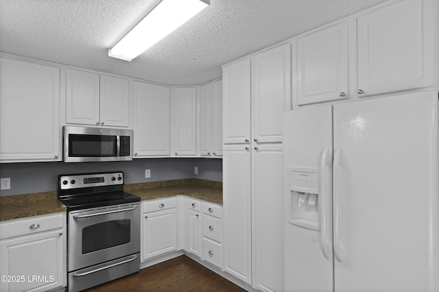 93 Heartstone Cir, Bluffton, SC 29910 - kitchen featuring appliances with stainless steel finishes, dark countertops, white cabinets, and a textured ceiling