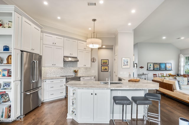 kitchen featuring pendant lighting, sink, stainless steel appliances, white cabinets, and decorative backsplash