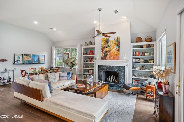 living room with dark wood-type flooring, ceiling fan, lofted ceiling, and a fireplace