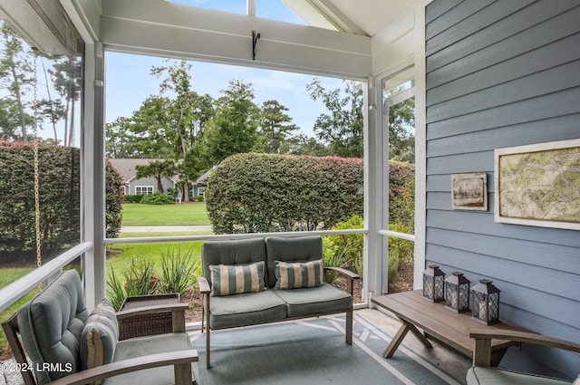 sunroom featuring plenty of natural light and vaulted ceiling