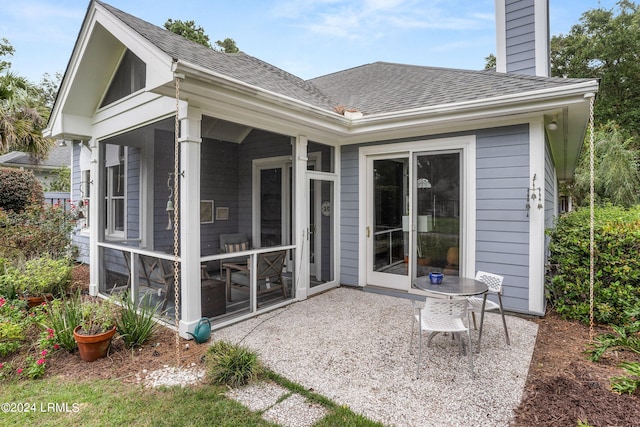 back of property with a patio area and a sunroom