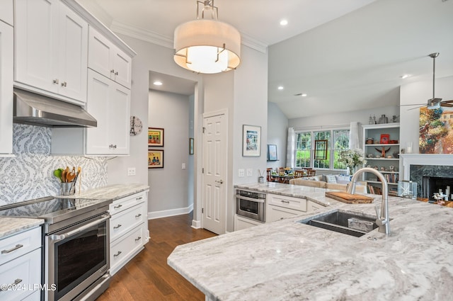 kitchen with sink, ventilation hood, hanging light fixtures, stainless steel appliances, and white cabinets