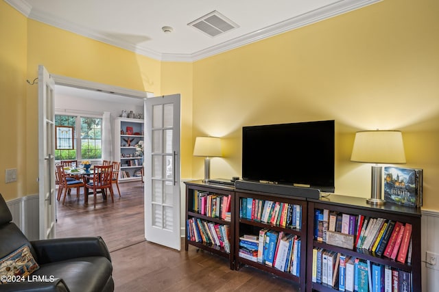 sitting room with ornamental molding, dark hardwood / wood-style floors, and french doors