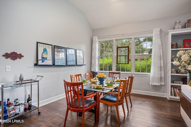 dining space featuring dark hardwood / wood-style flooring and vaulted ceiling