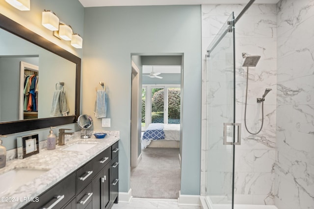 bathroom with a shower with door, vanity, and ceiling fan