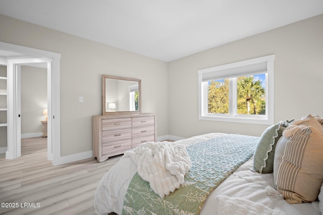 21 S Forest Beach Dr Unit 235, Hilton Head Island, SC 29928 - bedroom with light wood finished floors, baseboards, and multiple windows