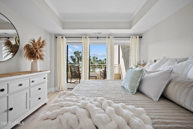 21 S Forest Beach Dr Unit 235, Hilton Head Island, SC 29928 - bedroom featuring ornamental molding, a raised ceiling, visible vents, and access to exterior