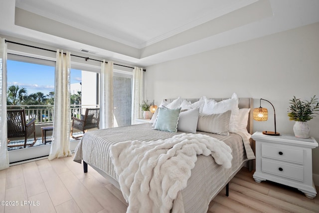 21 S Forest Beach Dr Unit 235, Hilton Head Island, SC 29928 - bedroom featuring light wood-style flooring, access to exterior, crown molding, visible vents, and a raised ceiling