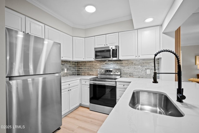 21 S Forest Beach Dr Unit 235, Hilton Head Island, SC 29928 - kitchen with a sink, crown molding, backsplash, stainless steel appliances, and white cabinets