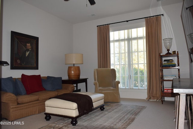 carpeted living room with a wealth of natural light and ceiling fan