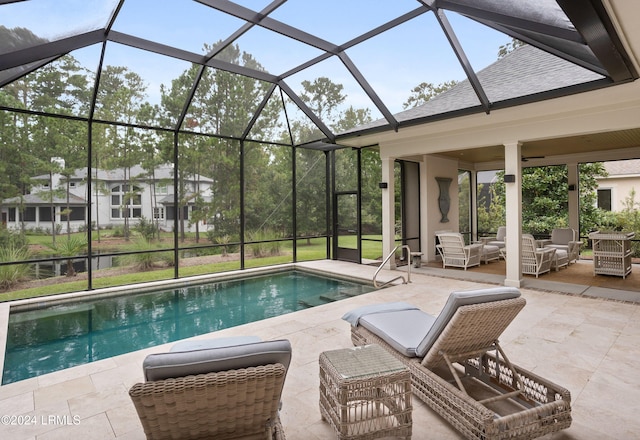 view of pool with ceiling fan, an outdoor hangout area, glass enclosure, and a patio