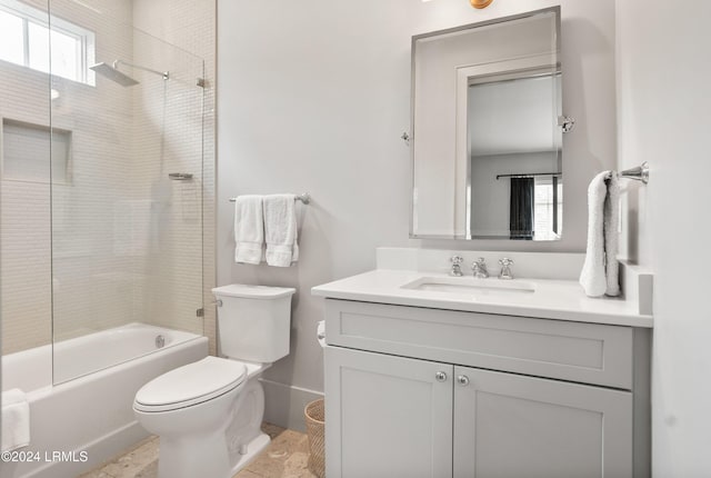 full bathroom featuring vanity, tiled shower / bath combo, plenty of natural light, and toilet