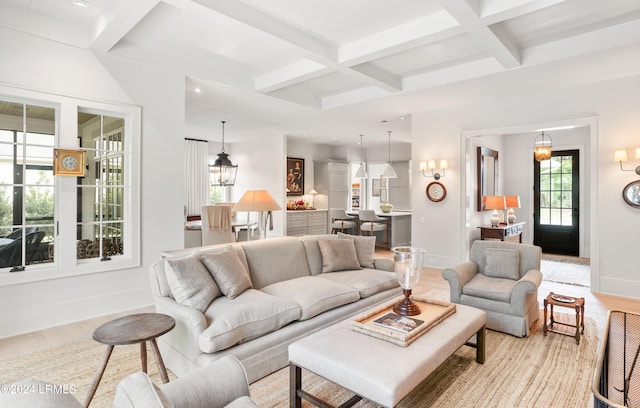 living room with coffered ceiling, beam ceiling, and light hardwood / wood-style flooring