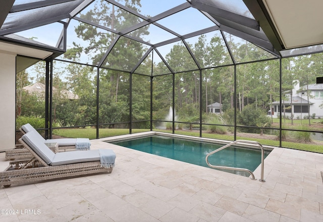 view of swimming pool with a patio and a lanai