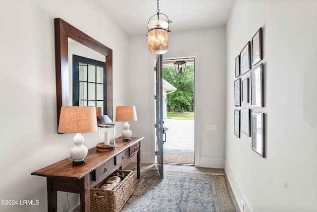 entryway featuring a chandelier