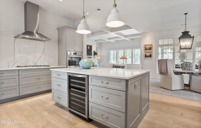 kitchen featuring wall chimney range hood, gray cabinets, stainless steel appliances, wine cooler, and tasteful backsplash