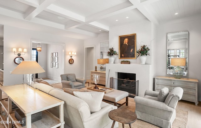 living room with coffered ceiling, plenty of natural light, beam ceiling, and light hardwood / wood-style flooring