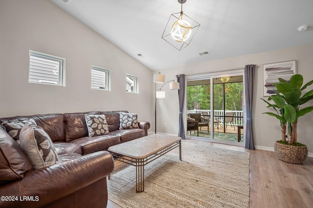 living room featuring light hardwood / wood-style flooring and vaulted ceiling