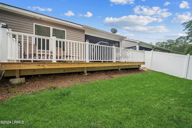 back of property with a lawn and a deck