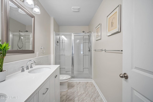 bathroom with vanity, a shower with shower door, and toilet