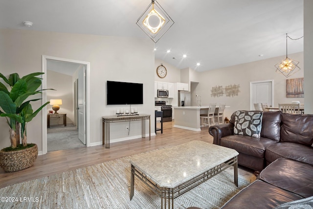 living room with lofted ceiling and light wood-type flooring