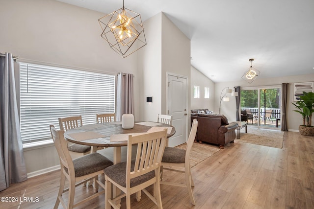 dining area with vaulted ceiling, light hardwood / wood-style flooring, and a notable chandelier