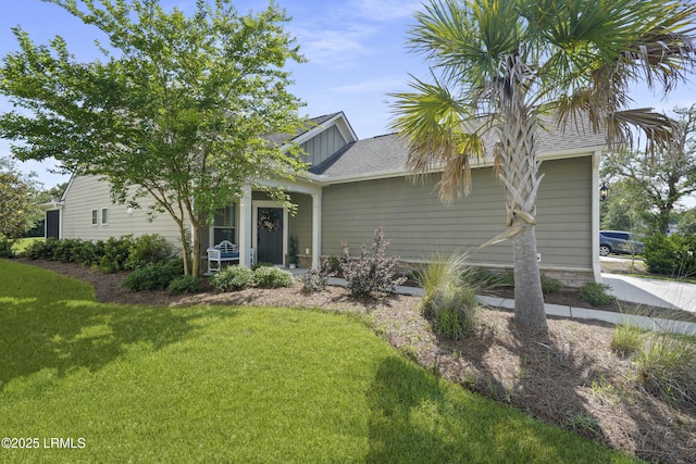 127 Kings Creek Dr, Bluffton, SC 29909 - view of front facade with a front lawn, roof with shingles, and board and batten siding