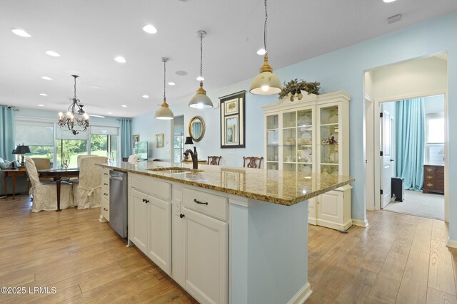 127 Kings Creek Dr, Bluffton, SC 29909 - kitchen with a sink, dishwasher, light wood-type flooring, light stone counters, and recessed lighting