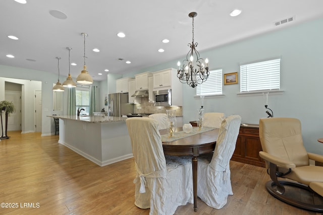 127 Kings Creek Dr, Bluffton, SC 29909 - dining room featuring light wood-style flooring, recessed lighting, and a chandelier