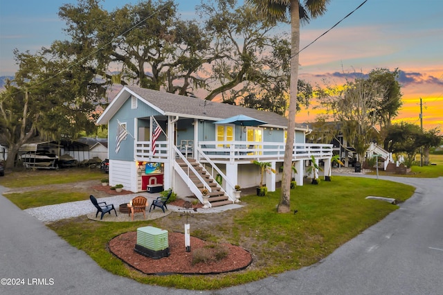 view of front of home featuring a yard and a fire pit