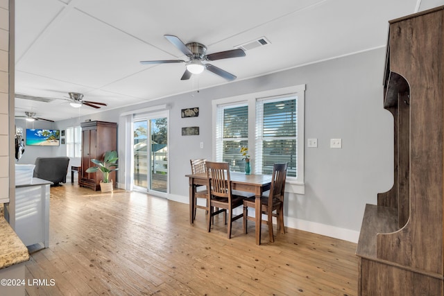 dining room featuring ceiling fan, light hardwood / wood-style floors, and a wealth of natural light