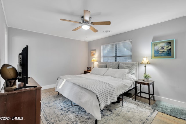 bedroom featuring hardwood / wood-style floors and ceiling fan