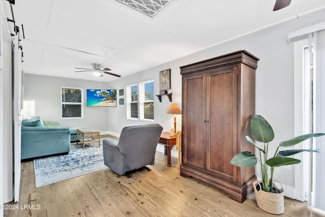 sitting room featuring ceiling fan and light wood-type flooring