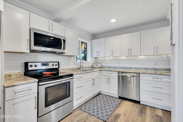 kitchen featuring white cabinetry, sink, stainless steel appliances, light stone countertops, and light hardwood / wood-style flooring