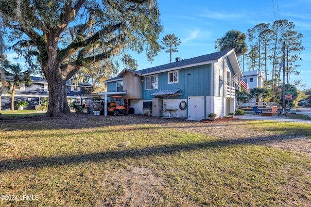 rear view of house featuring a lawn