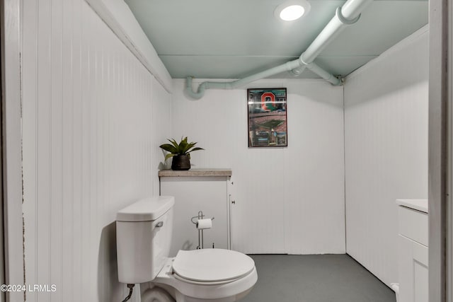 bathroom featuring vanity, toilet, and concrete floors