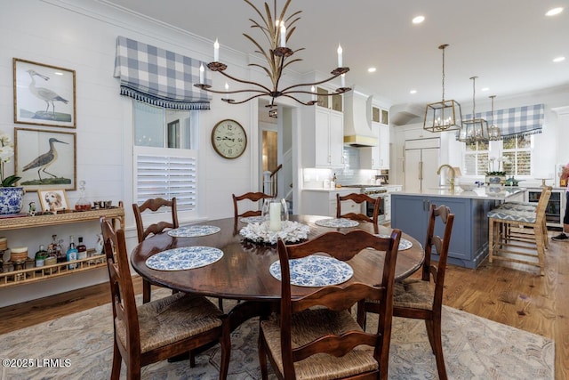 dining space featuring ornamental molding, recessed lighting, and light wood-style floors