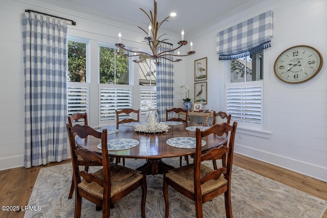 dining space featuring baseboards, ornamental molding, wood finished floors, a chandelier, and recessed lighting