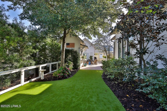 view of yard featuring a patio and fence