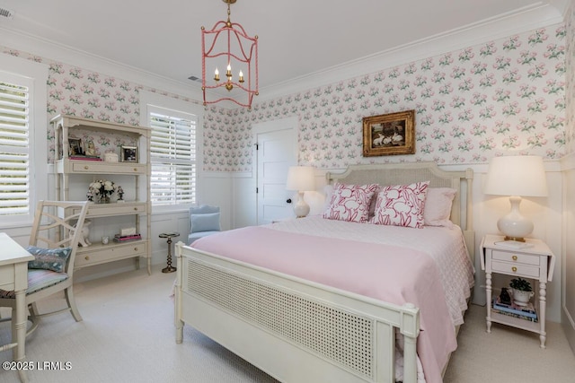 bedroom featuring ornamental molding, wainscoting, and wallpapered walls