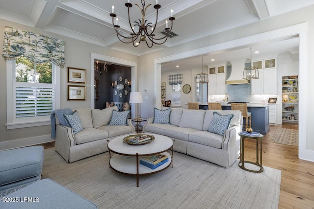 living area with beamed ceiling, light wood-type flooring, coffered ceiling, and a notable chandelier