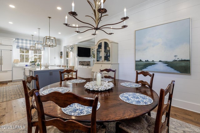 dining room featuring crown molding, wood finished floors, and recessed lighting