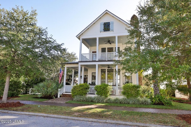 view of front of home featuring a ceiling fan, covered porch, and a balcony