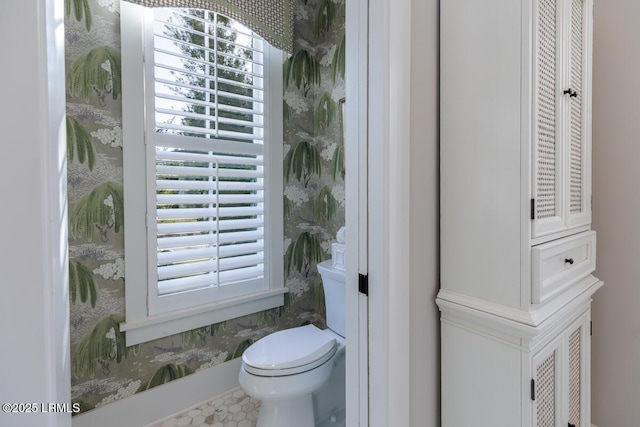 bathroom featuring a healthy amount of sunlight and toilet