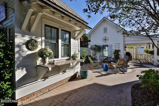 view of patio / terrace with an outdoor fire pit and fence