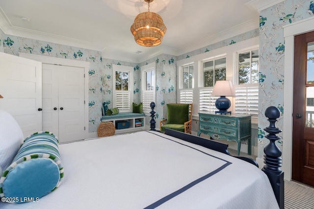 carpeted bedroom featuring ornamental molding, a closet, and wallpapered walls