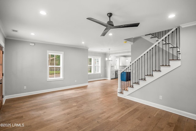 9 Attaway Ln, Beaufort, SC 29907 - unfurnished living room featuring crown molding, recessed lighting, ceiling fan, baseboards, and stairway