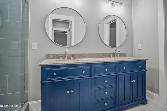 9 Attaway Ln, Beaufort, SC 29907 - bathroom featuring double vanity, baseboards, and tiled shower