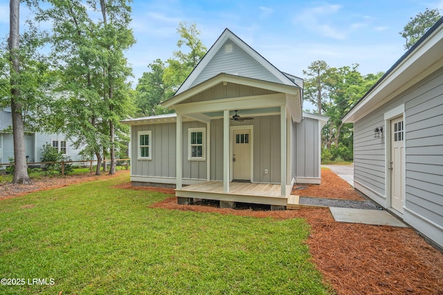 9 Attaway Ln, Beaufort, SC 29907 - rear view of house featuring board and batten siding, a ceiling fan, a yard, and a wooden deck
